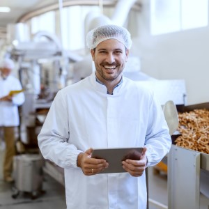 Photo of food production manager with software tablet